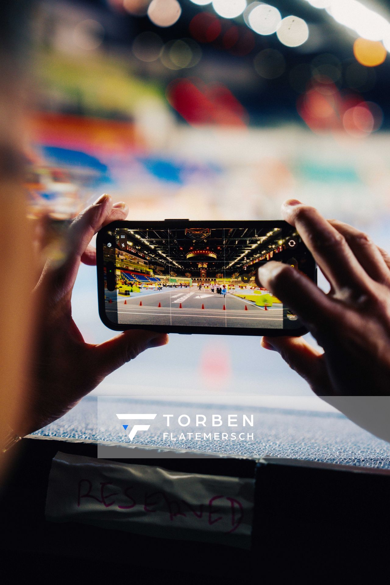 A person capturing photos using a smartphone on 19.03.2026 at the World Athletics Indoor Championships 2026 in Torun